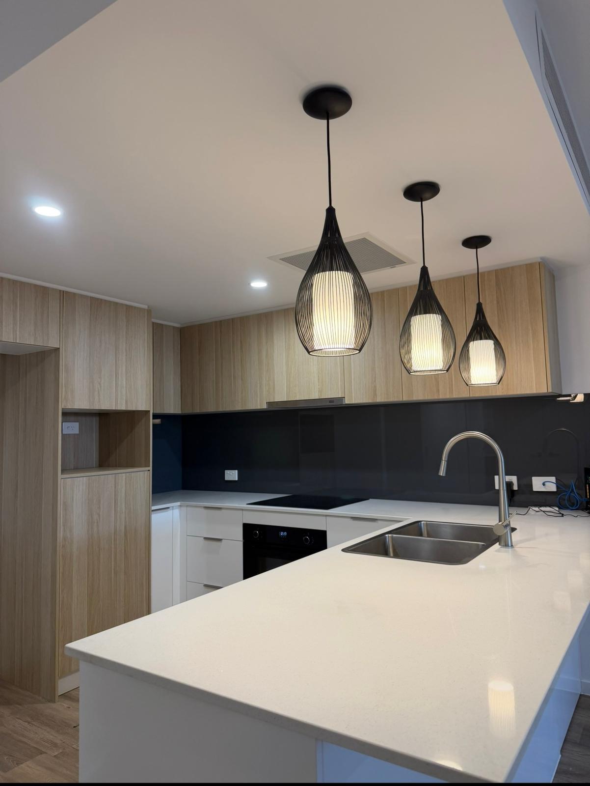 Freshly cleaned modern kitchen with pendant lights